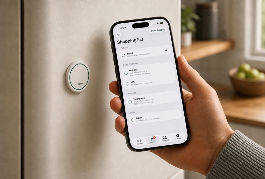 StockUp on a fridge, beside an iPhone showing the shared shopping list